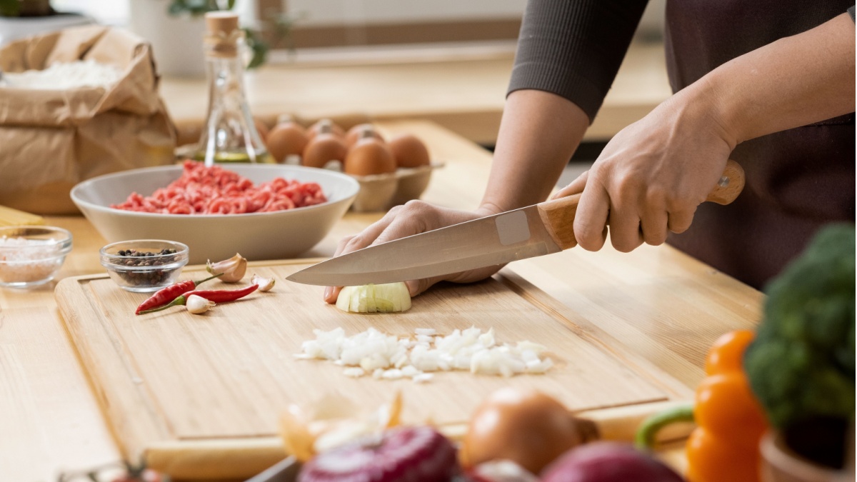 Chef holding two wooden spoons