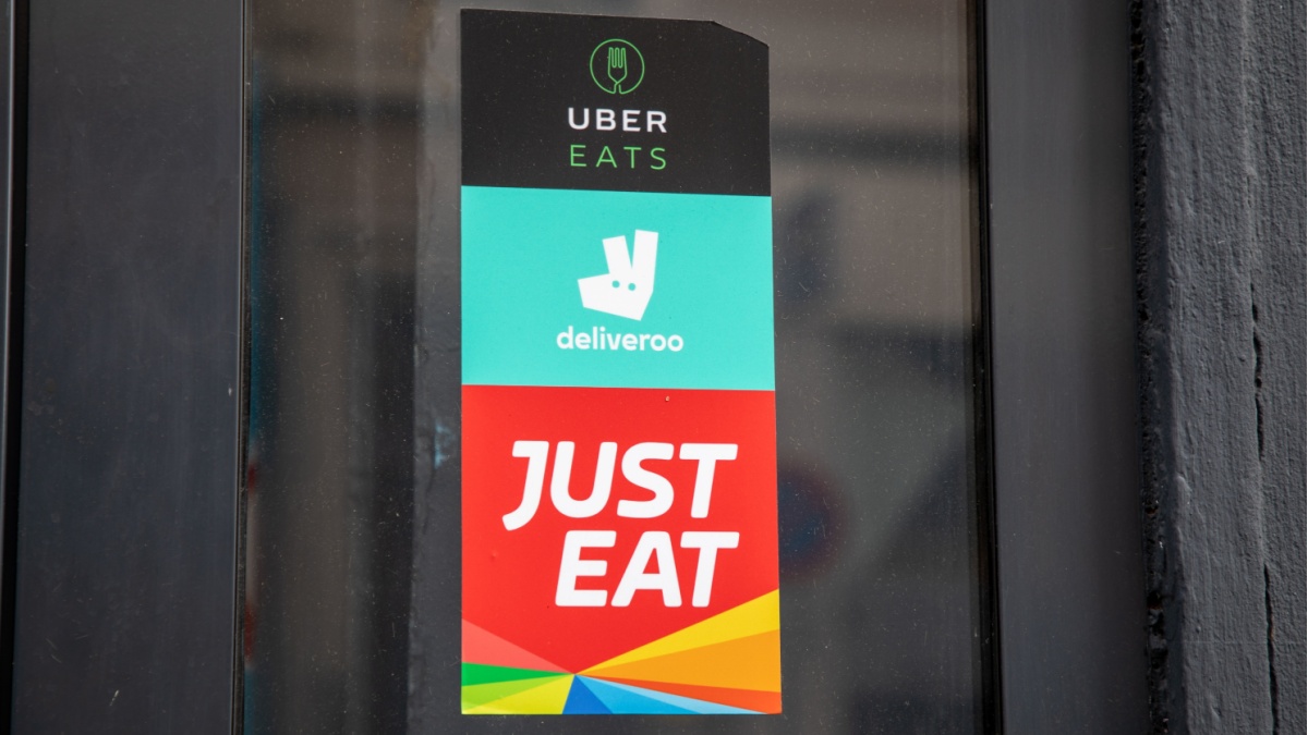 Poster in restaurant window showing food delivery apps