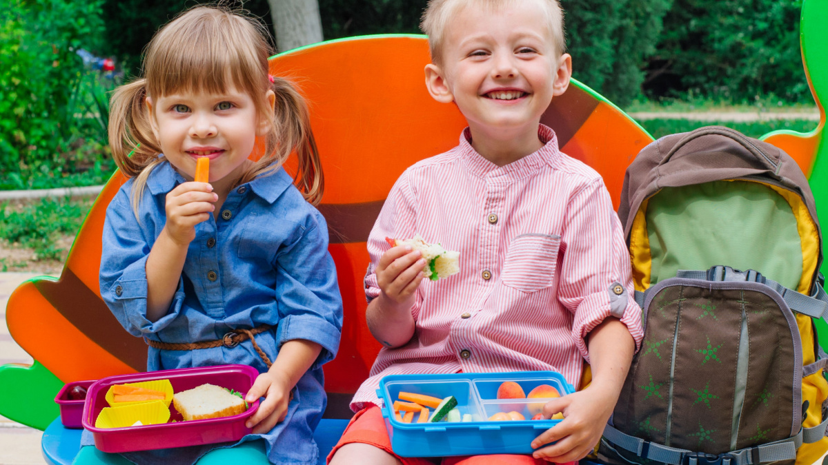 Kid's lunchbox with healthy food arranged in smiley face