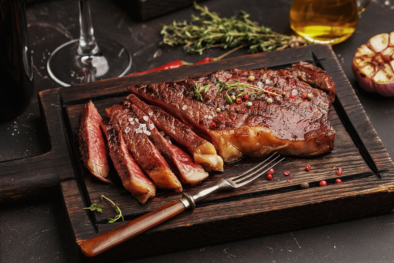 Medium rare steak on a wooden board